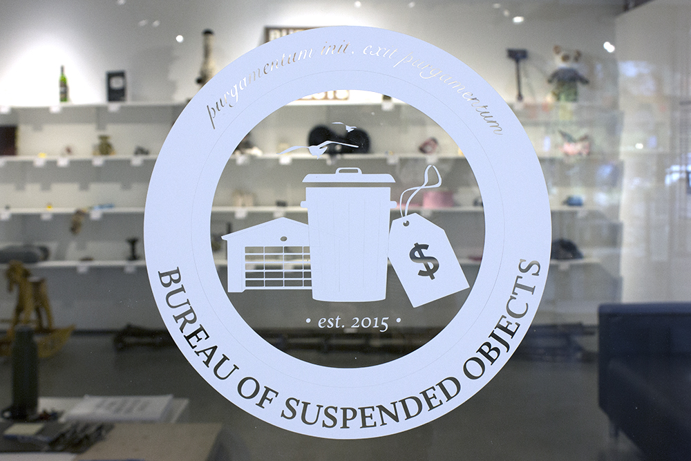 the logo for the Bureau of Suspended Objects on the door of the gallery