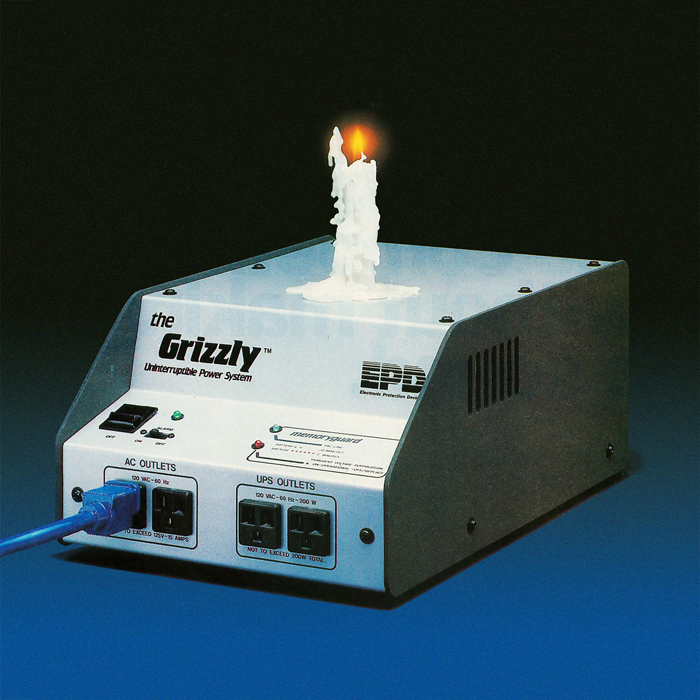 A plugged-in power system device with a burning candle on top of it