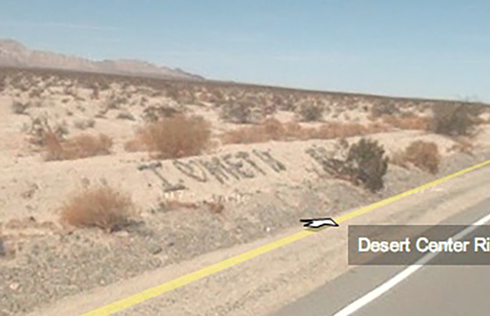 Screenshot of Street View of a remote desert road on which someone has spelled out in rocks: I Heart Meth
