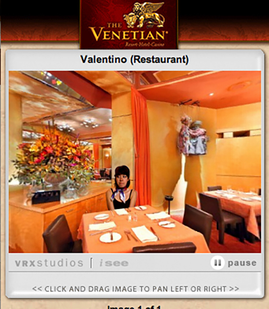 Jenny Odell appearing to sit awkwardly and alone at a dinner table inside the window for a virtual tour of the Valentino Restaurant at the Venetian in Las Vegas